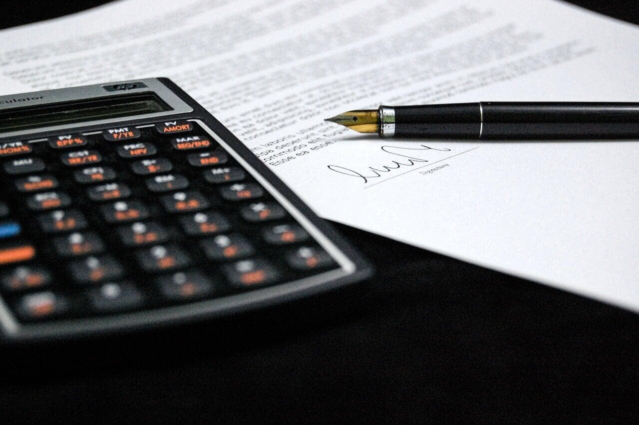 Calculator and pen signing document